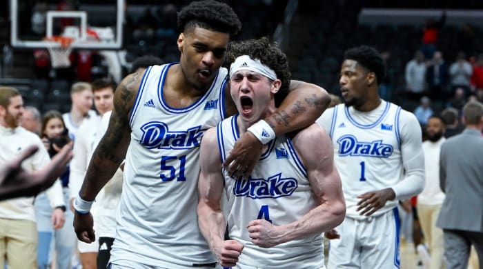 Drake Bulldogs guard Conor Enright (4) and forward Darnell Brodie (51) celebrate after the Bulldogs defeated the Bradley Braves in the Missouri Valley Conference Tournament semifinal game at Enterprise Center in St. Louis on March 9, 2024.
